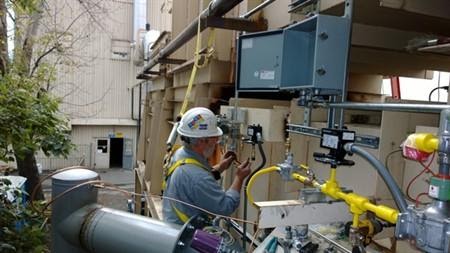 Worker performing maintenance on oxidizer system